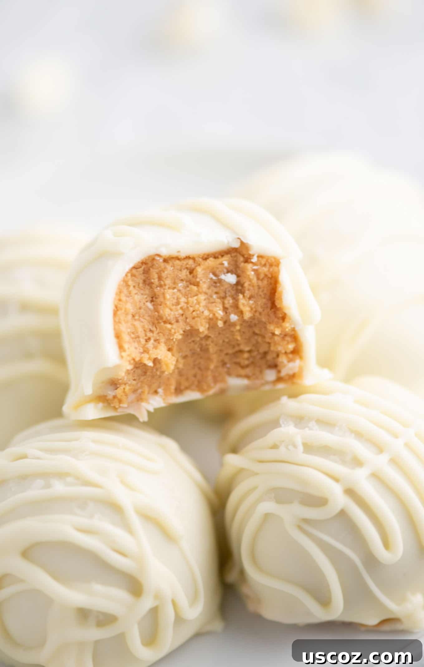 Decadent White Chocolate Peanut Butter Bliss Balls 4 white chocolate peanut butter ball with a bite taken out