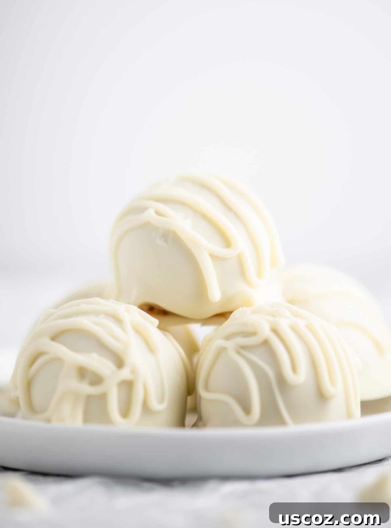 Decadent White Chocolate Peanut Butter Bliss Balls 5 peanut butter truffles from the side view