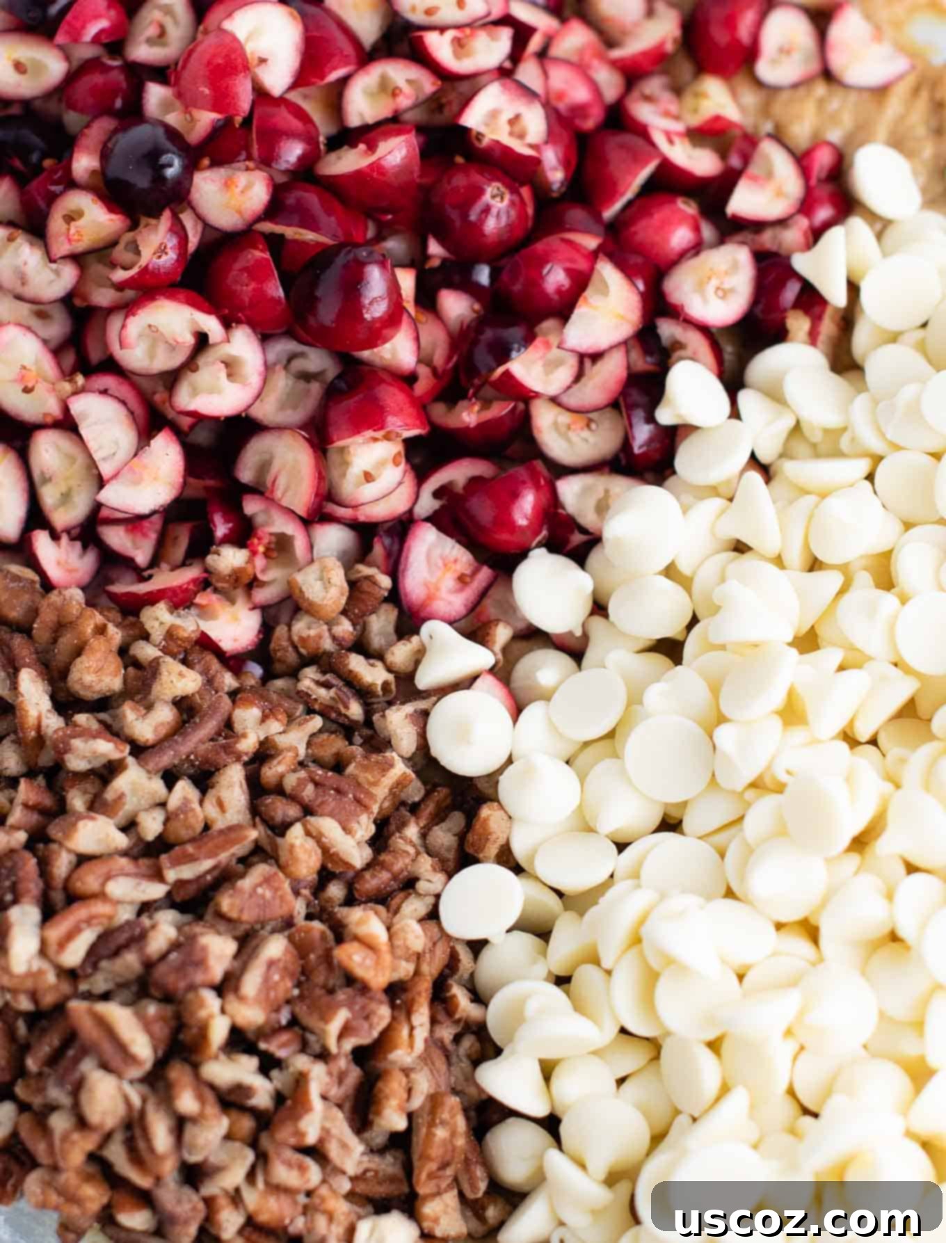 Cranberry Pecan White Chocolate Indulgence 5 Close-up of vibrant chopped fresh cranberries, crunchy chopped pecans, and sweet white chocolate baking chips, ready to be folded into cookie dough