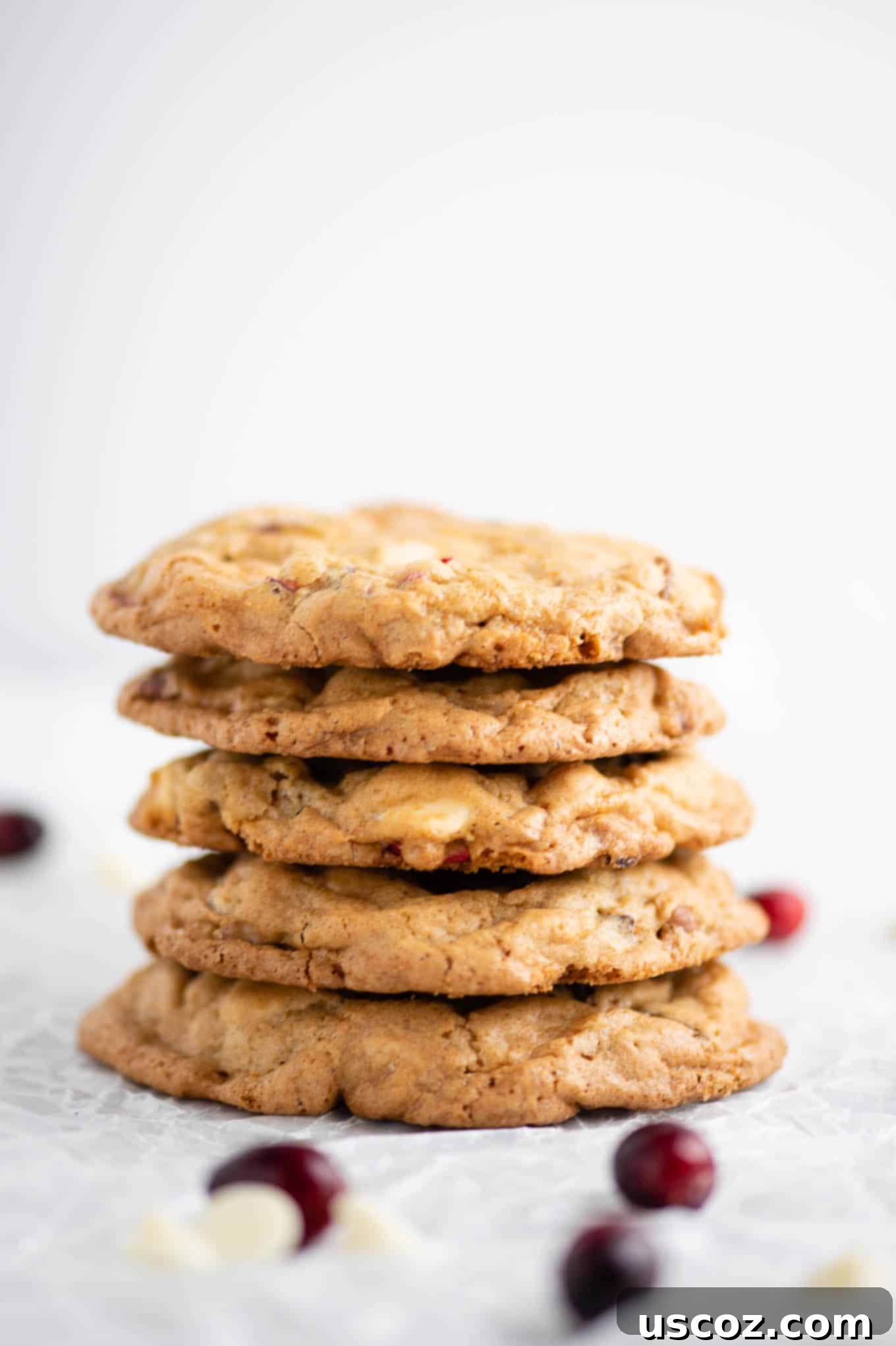 Cranberry Pecan White Chocolate Indulgence 8 Close-up view of stacked white chocolate cranberry pecan cookies, highlighting their delicious texture and ingredients