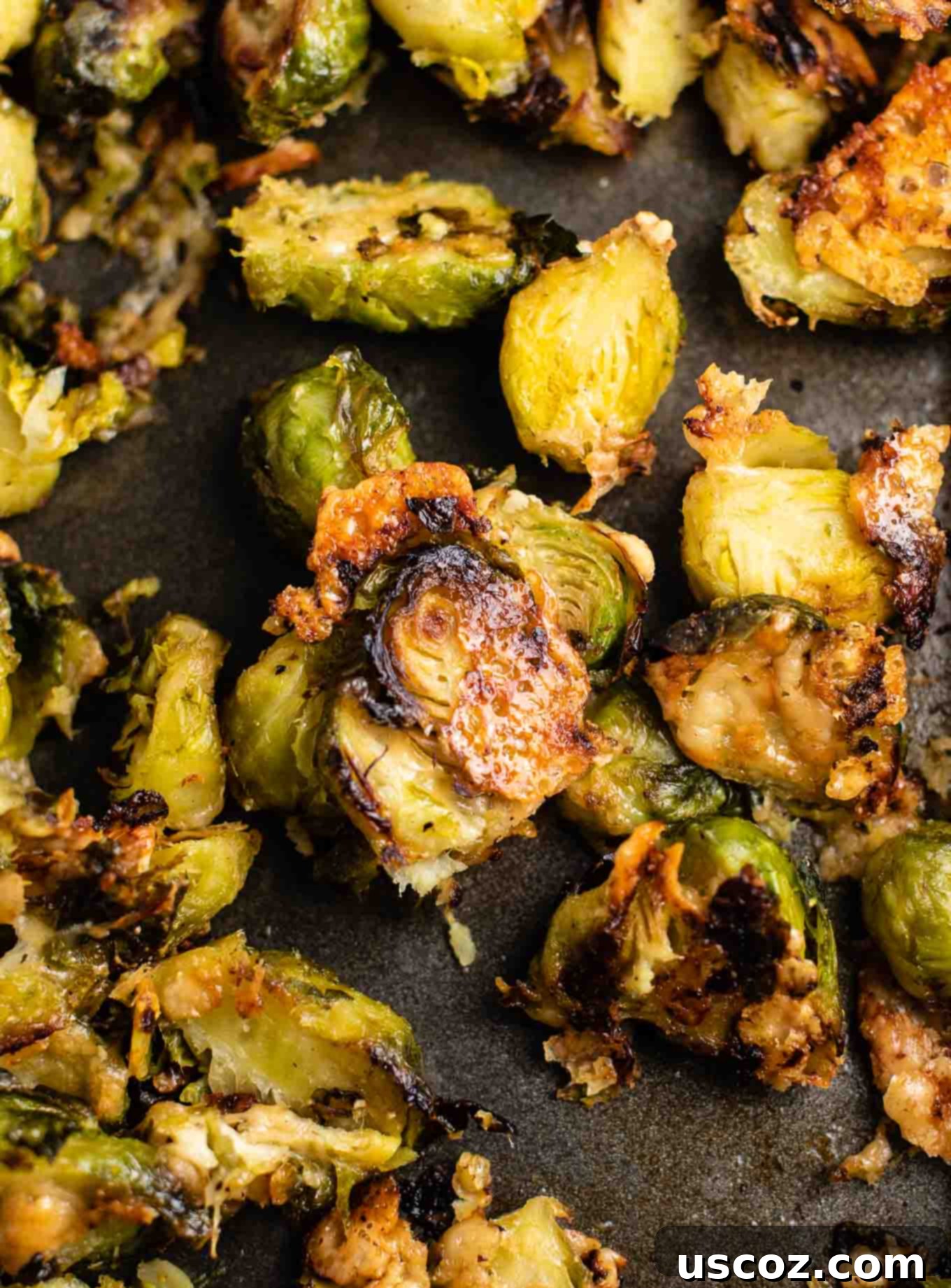 Crispy Roasted Frozen Brussels Sprouts 3 roasted frozen brussel sprouts on a black baking sheet