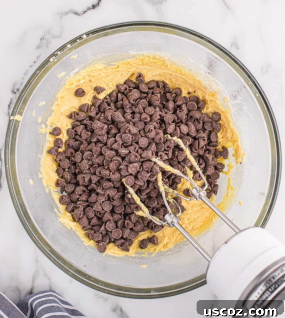 Cake Mix Cookie Squares 7 adding chocolate chips to the thick cake mix cookie bar batter
