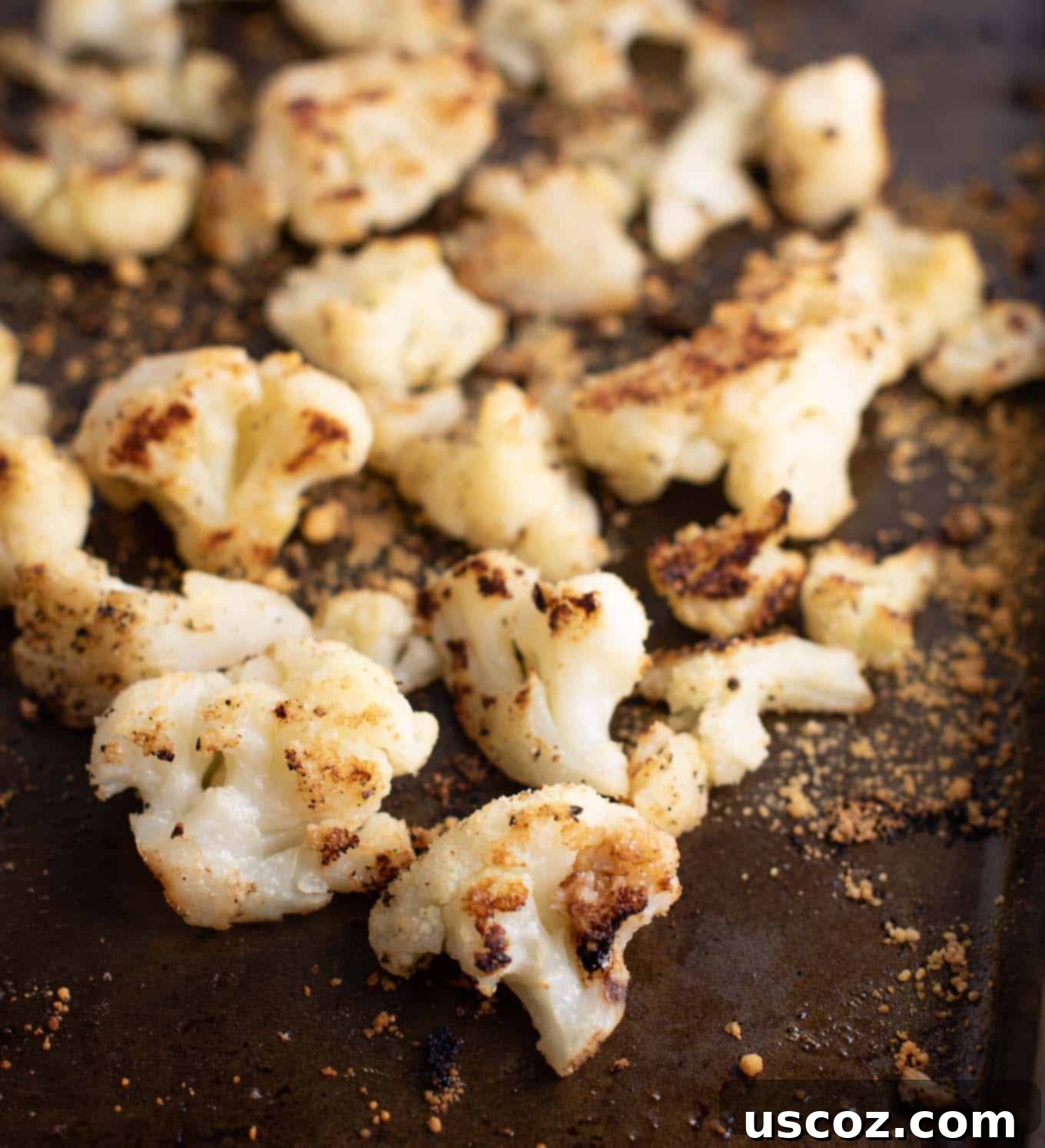 Crispy Roasted Frozen Cauliflower 3 Close-up of golden-brown and crispy roasted cauliflower on a baking sheet