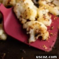 Crispy Roasted Frozen Cauliflower 8 a red spatula with roasted frozen cauliflower on it