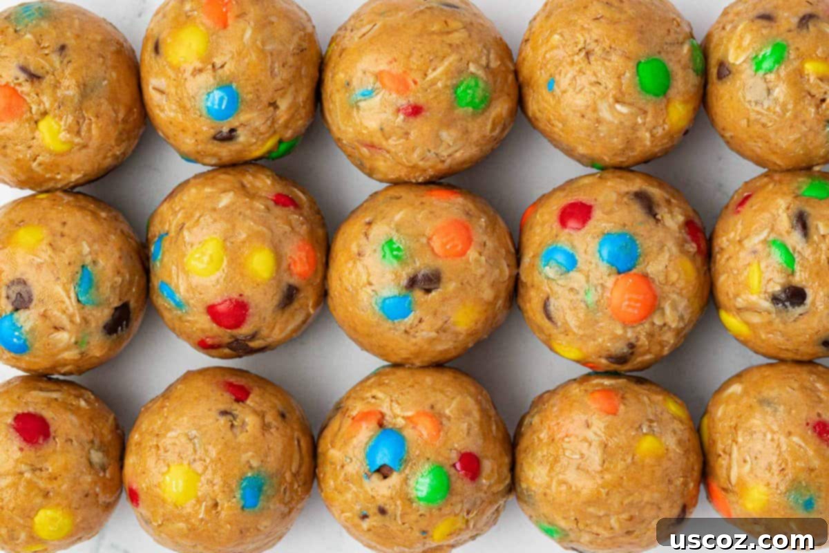 Monster Cookie Energy Bites 14 A generous pile of monster cookie protein balls on a rustic wooden surface, highlighting their homemade charm.