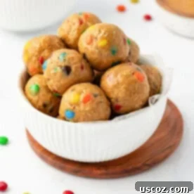 Monster Cookie Energy Bites 15 A bowl brimming with colorful Monster Cookie Energy Balls, ready to be enjoyed.