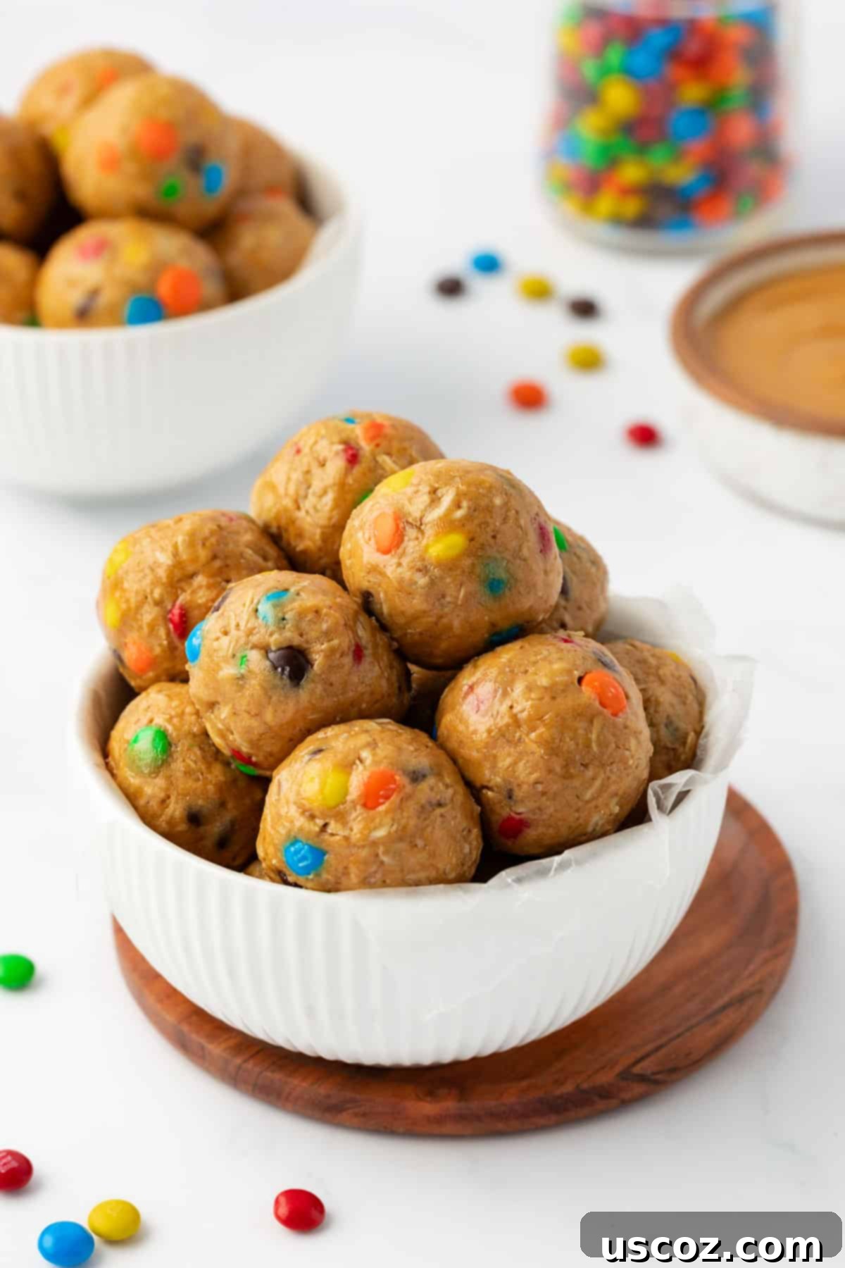 Monster Cookie Energy Bites 3 A close-up shot of perfectly formed monster cookie bites arranged artfully, showcasing their colorful M&M's and chocolate chips.