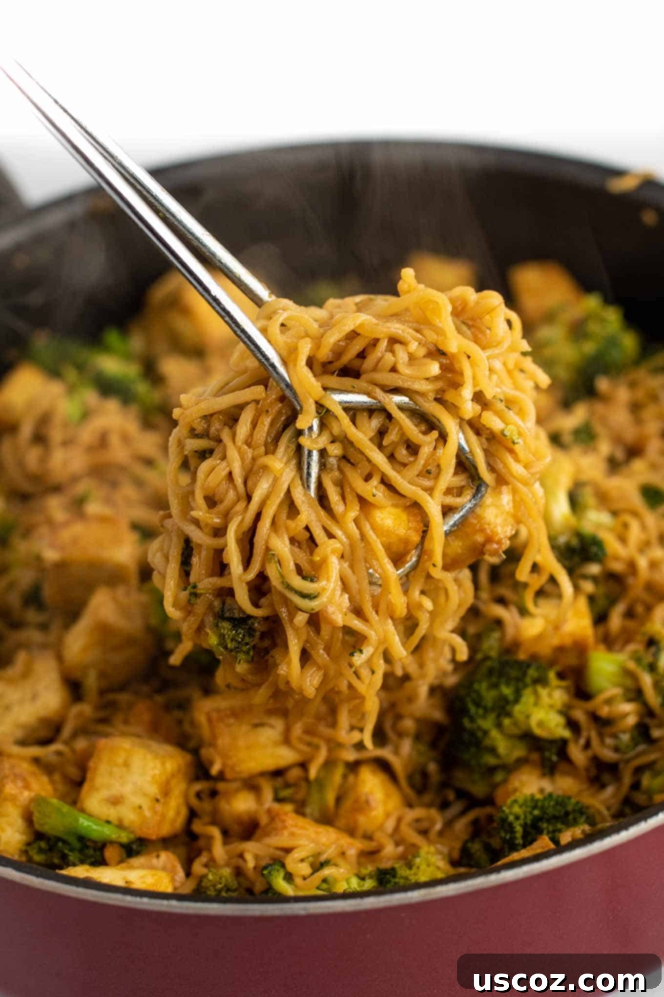 Savory Broccoli Tofu Ramen 12 tongs grabbing a serving of ramen noodle stir fry
