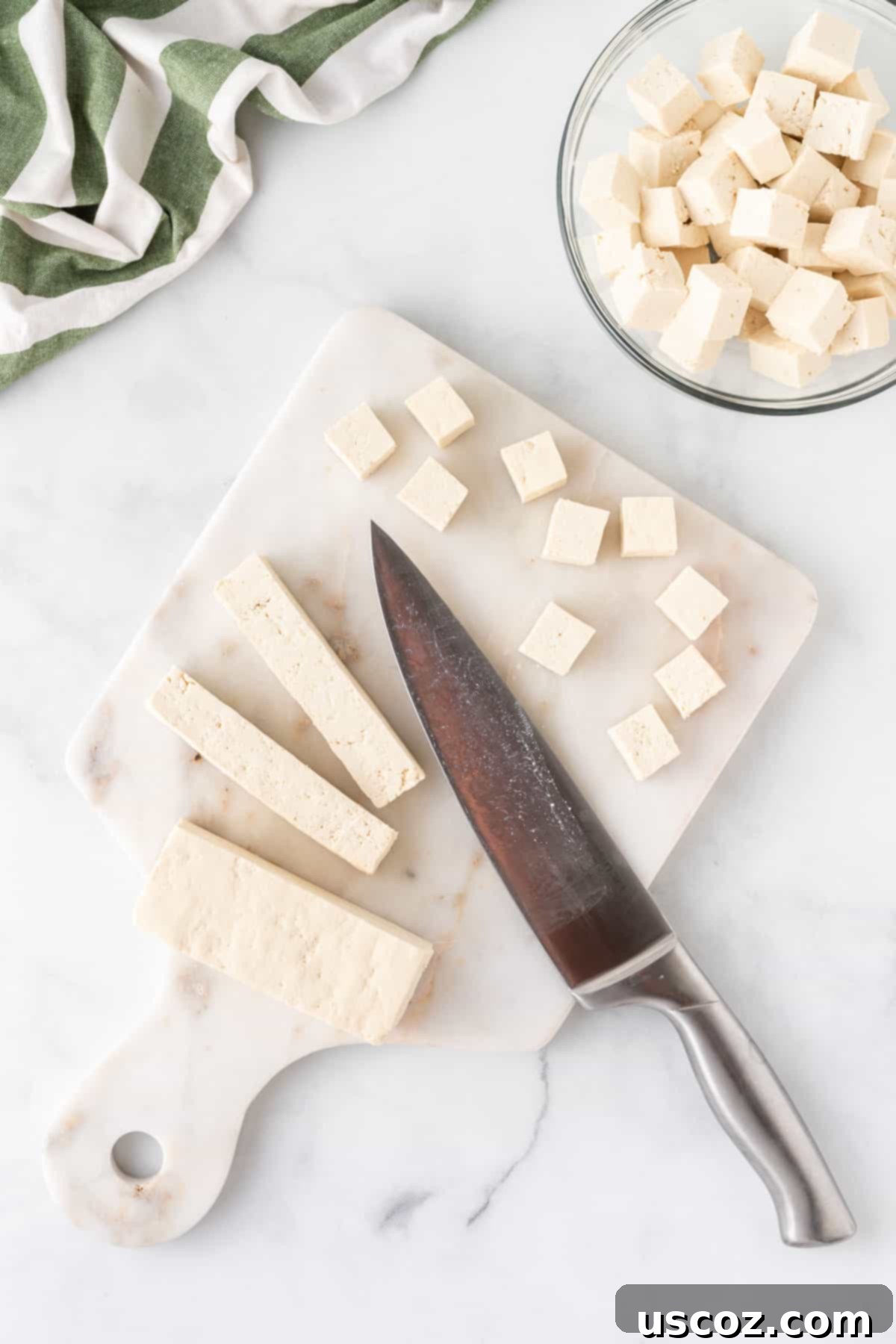Zesty Orange Tofu 6 cutting tofu into cubes on a cutting board