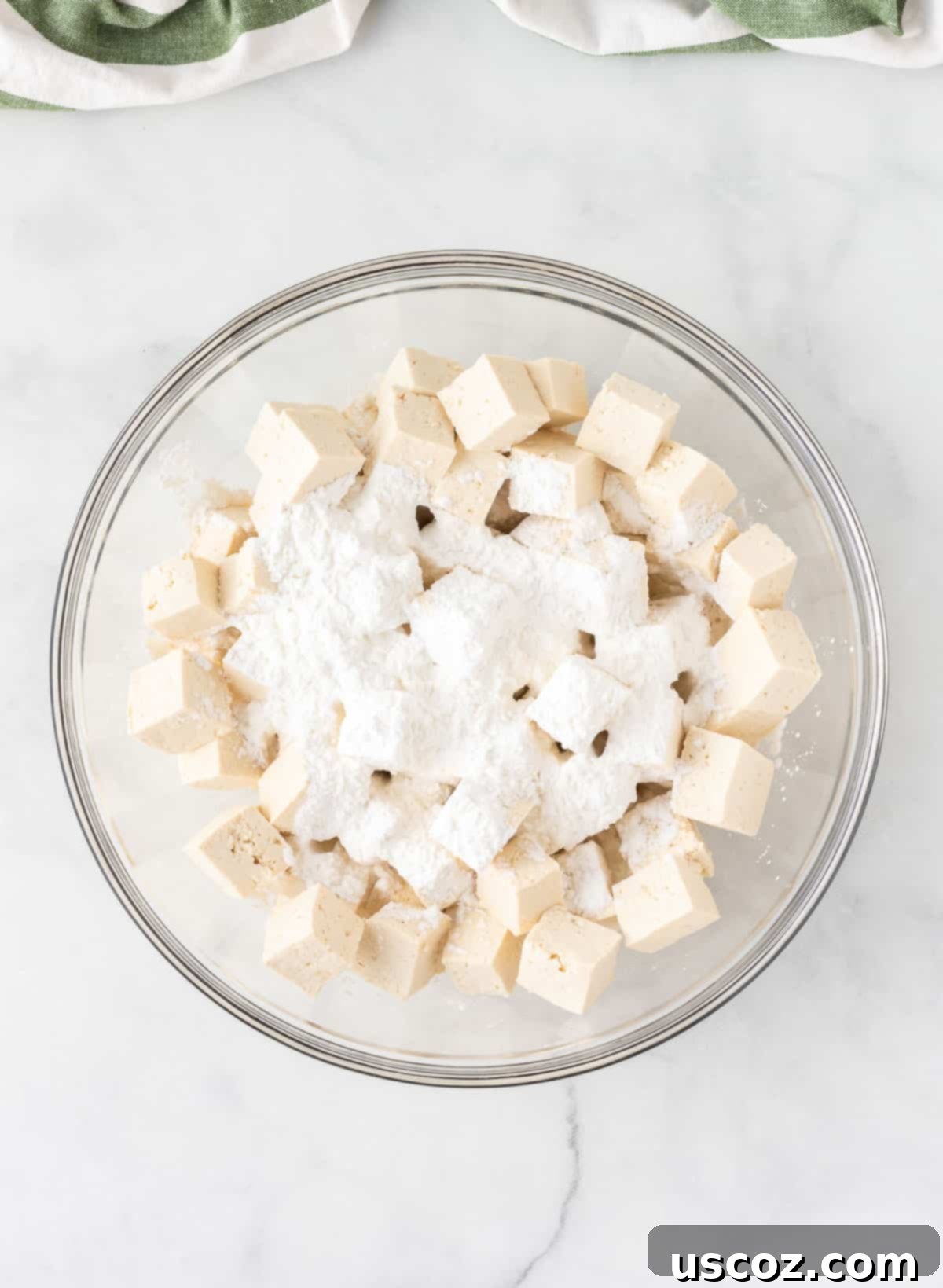 Zesty Orange Tofu 7 cubed tofu in a bowl with corn starch on top