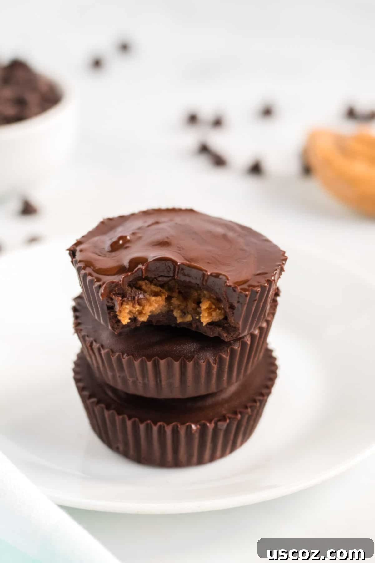 Plant-Based Peanut Butter Perfection 11 stacked peanut butter cups with a bite taken out