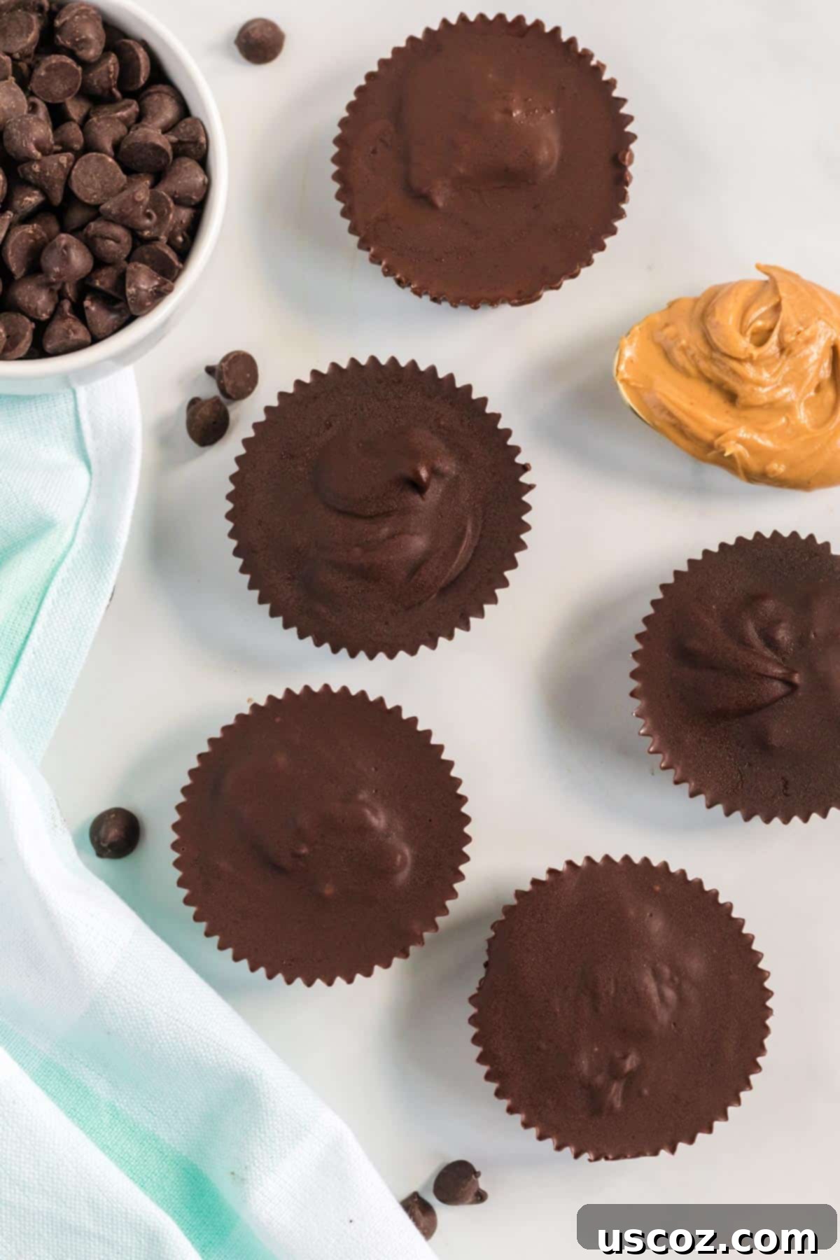Plant-Based Peanut Butter Perfection 3 peanut butter cups lined up next to a spoon of peanut butter