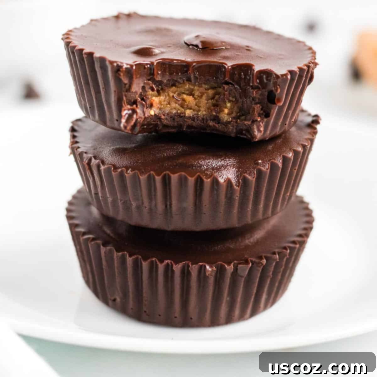 Plant-Based Peanut Butter Perfection 9 stacked peanut butter cups with a bite taken out