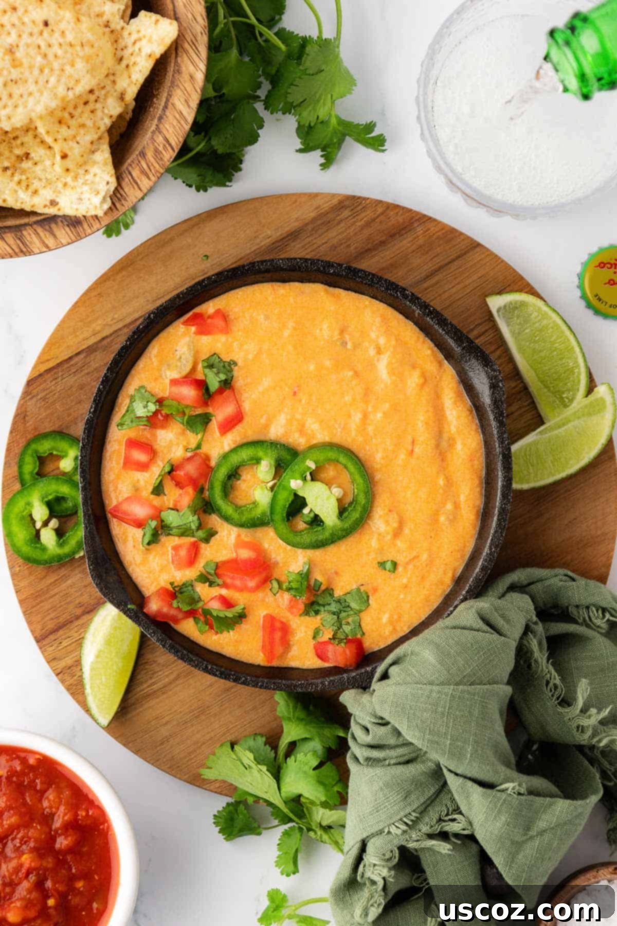 Easy Crock Pot Queso Dip 9 queso dip in a serving dish topped with pico and jalapenos