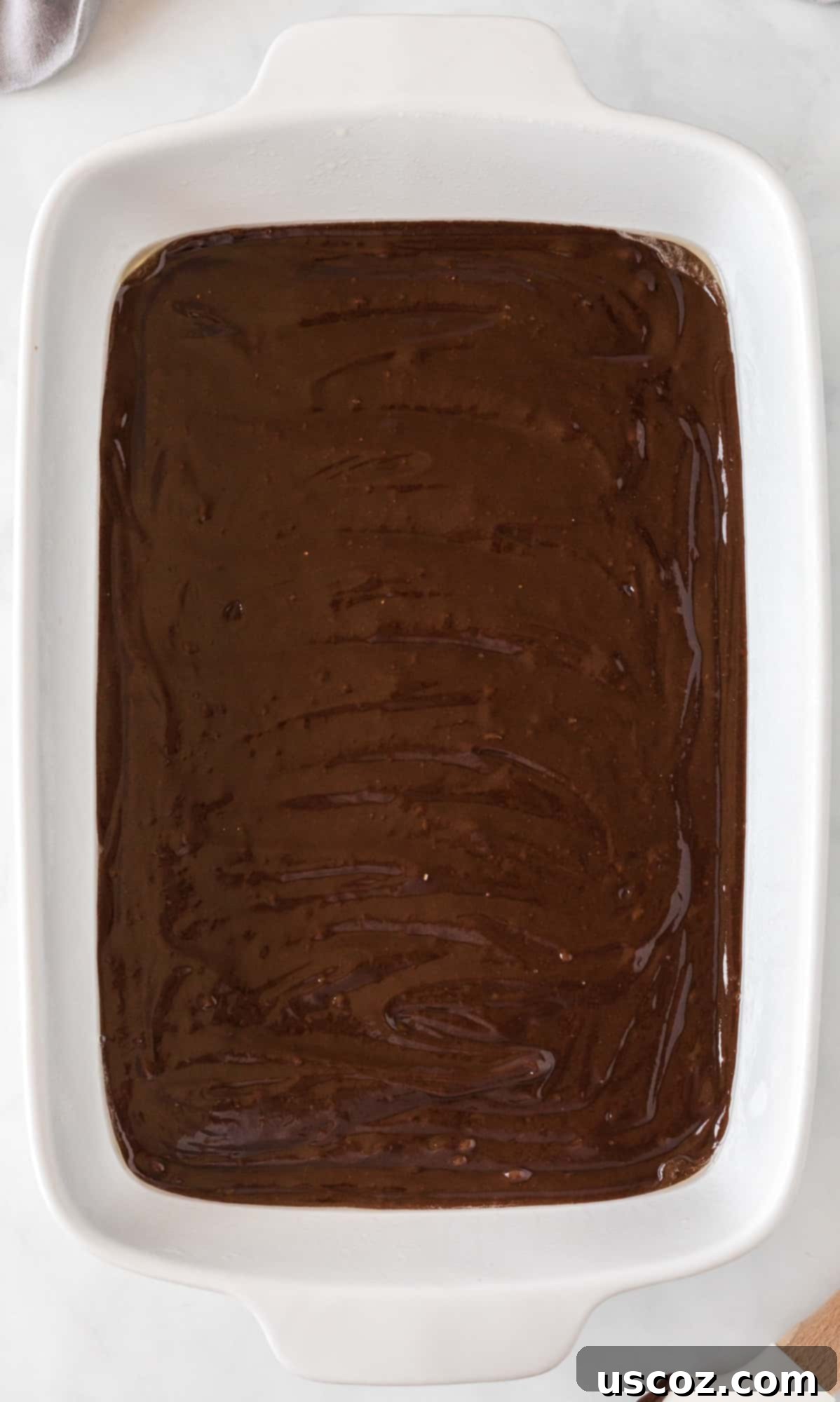 Ultimate Pecan Pie Brownies 7 brownie mix spread out in a 9 by 13 baking dish