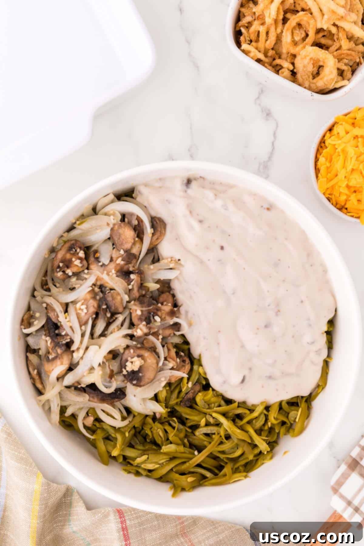 mixing together cream of mushroom soup, mushrooms, and green beans