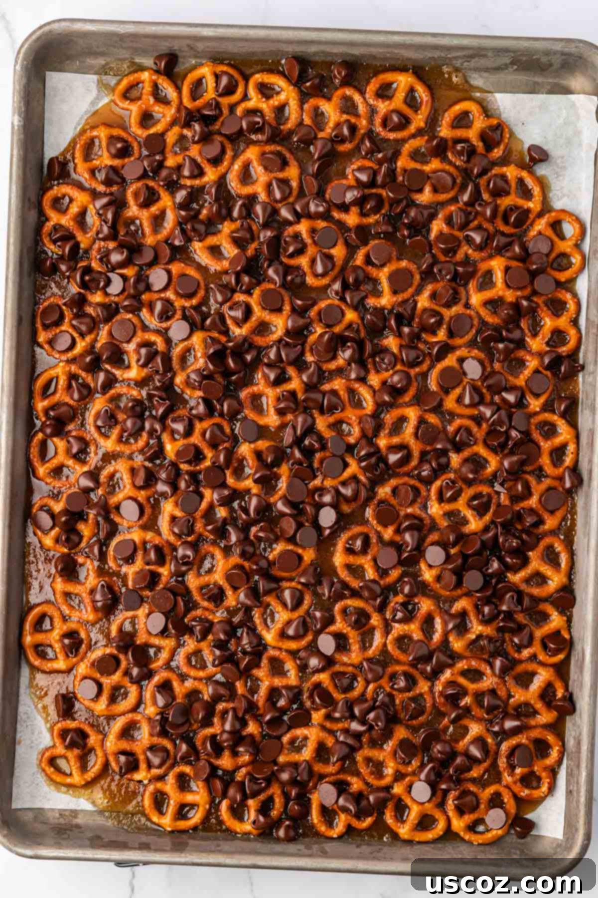Holiday Pretzel Crunch 13 chocolate chips sprinkled over the toffee pretzels