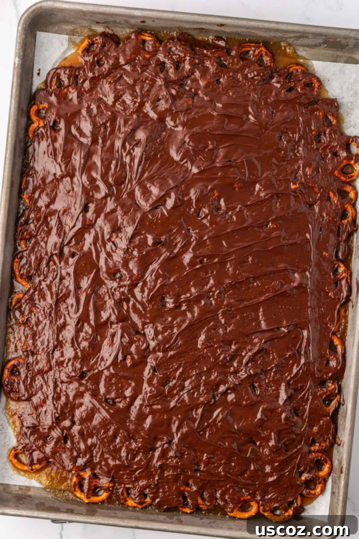 Holiday Pretzel Crunch 16 melted chocolate spread over toffee pretzels