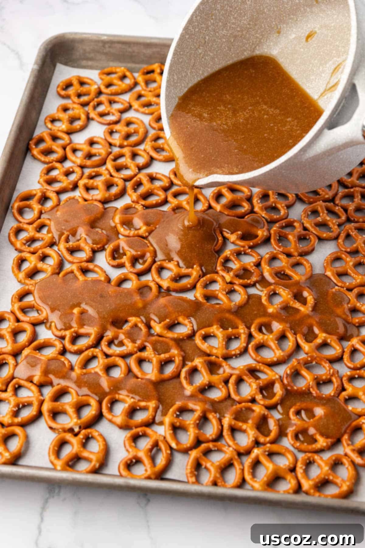 Holiday Pretzel Crunch 8 pouring the toffee over the pretzels
