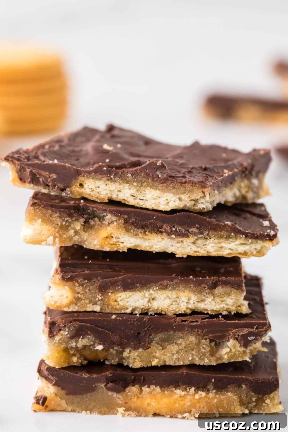 Sweet and Salty Ritz Cracker Toffee 2 Stacked pieces of delicious Ritz Cracker Toffee, showcasing its chocolate and cracker layers.