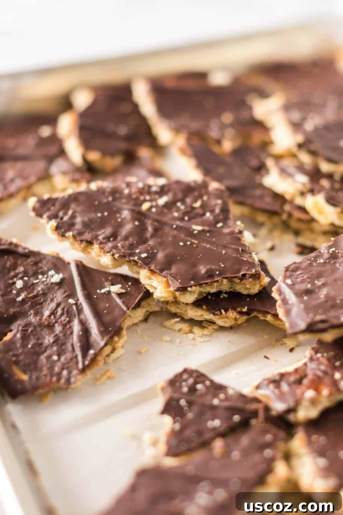 Sweet and Salty Ritz Cracker Toffee 11 Ritz Cracker Toffee set and glistening on a baking sheet, ready to be broken into pieces.
