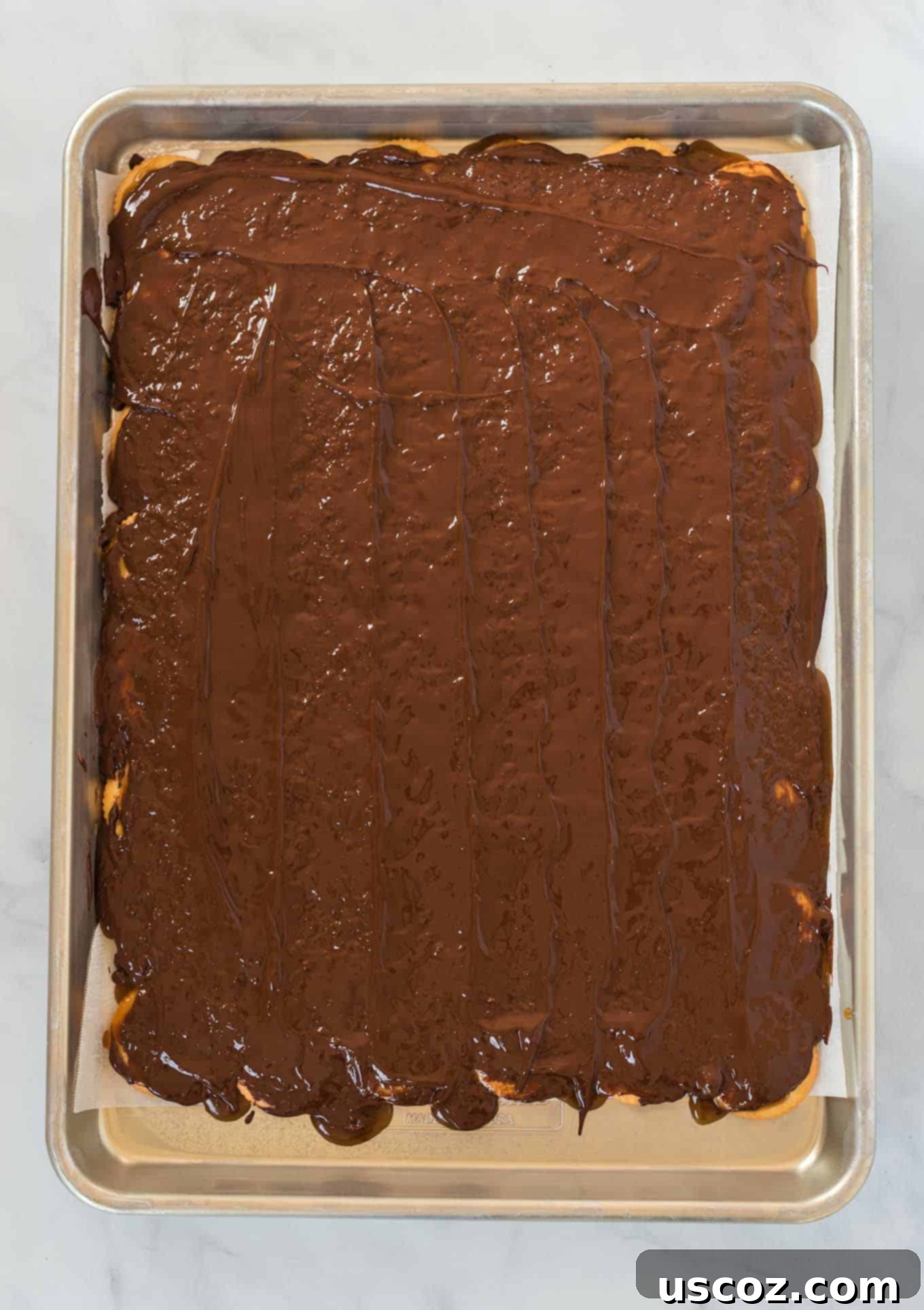 Sweet and Salty Ritz Cracker Toffee 7 Baking sheet filled with Ritz crackers covered in warm, bubbly toffee and melting chocolate.