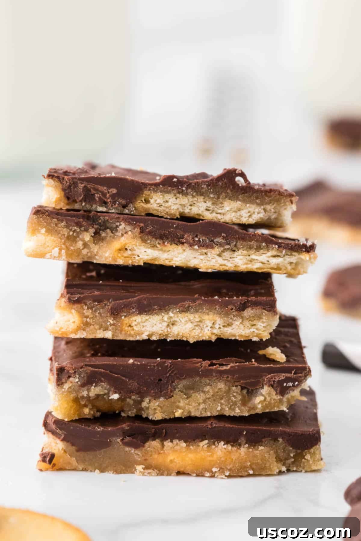Sweet and Salty Ritz Cracker Toffee 8 More stacked pieces of Ritz Cracker Toffee, highlighting the delicate crunch and rich chocolate.