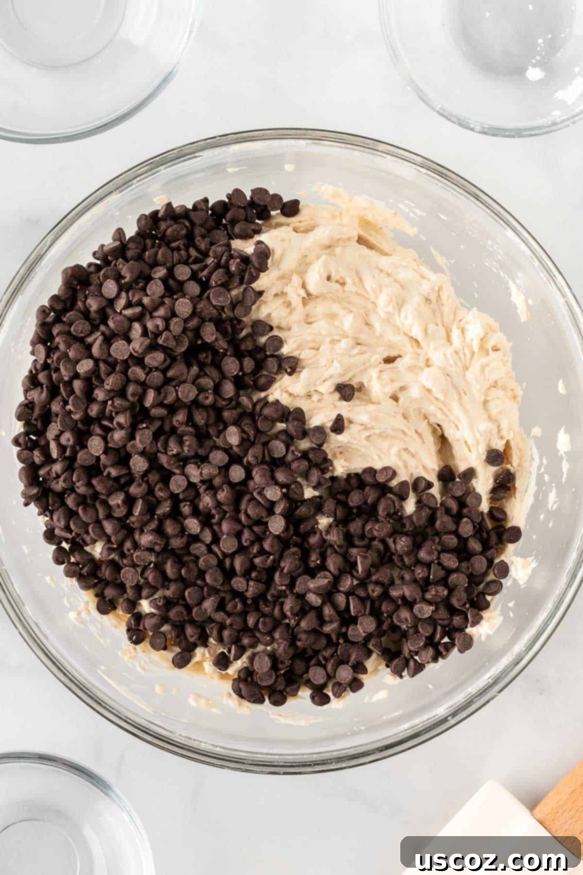 Chocolate Chip Cheese Ball Delight 8 Mini chocolate chips being added to the mixed cheese ball batter.