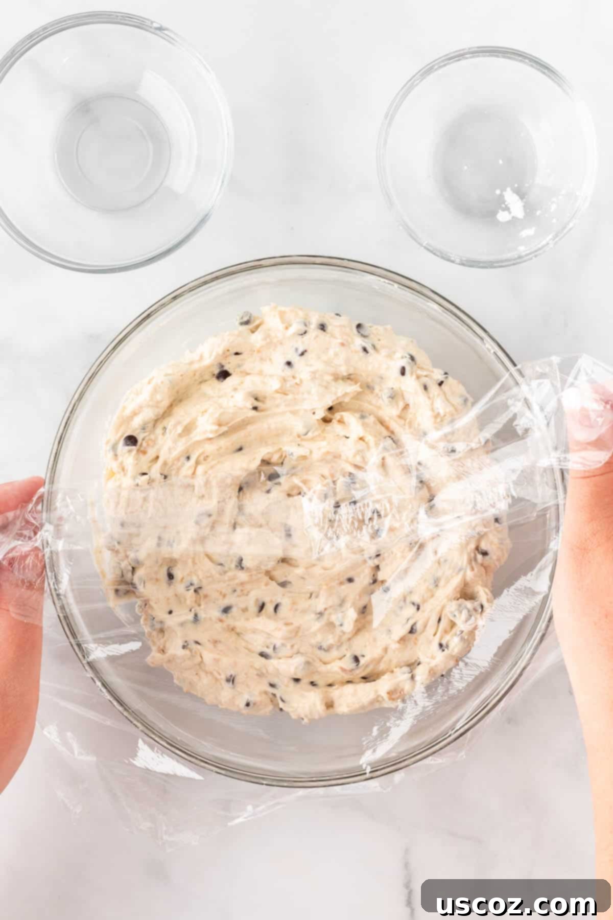 Chocolate Chip Cheese Ball Delight 10 The cheese ball batter covered with plastic wrap in the refrigerator for chilling.