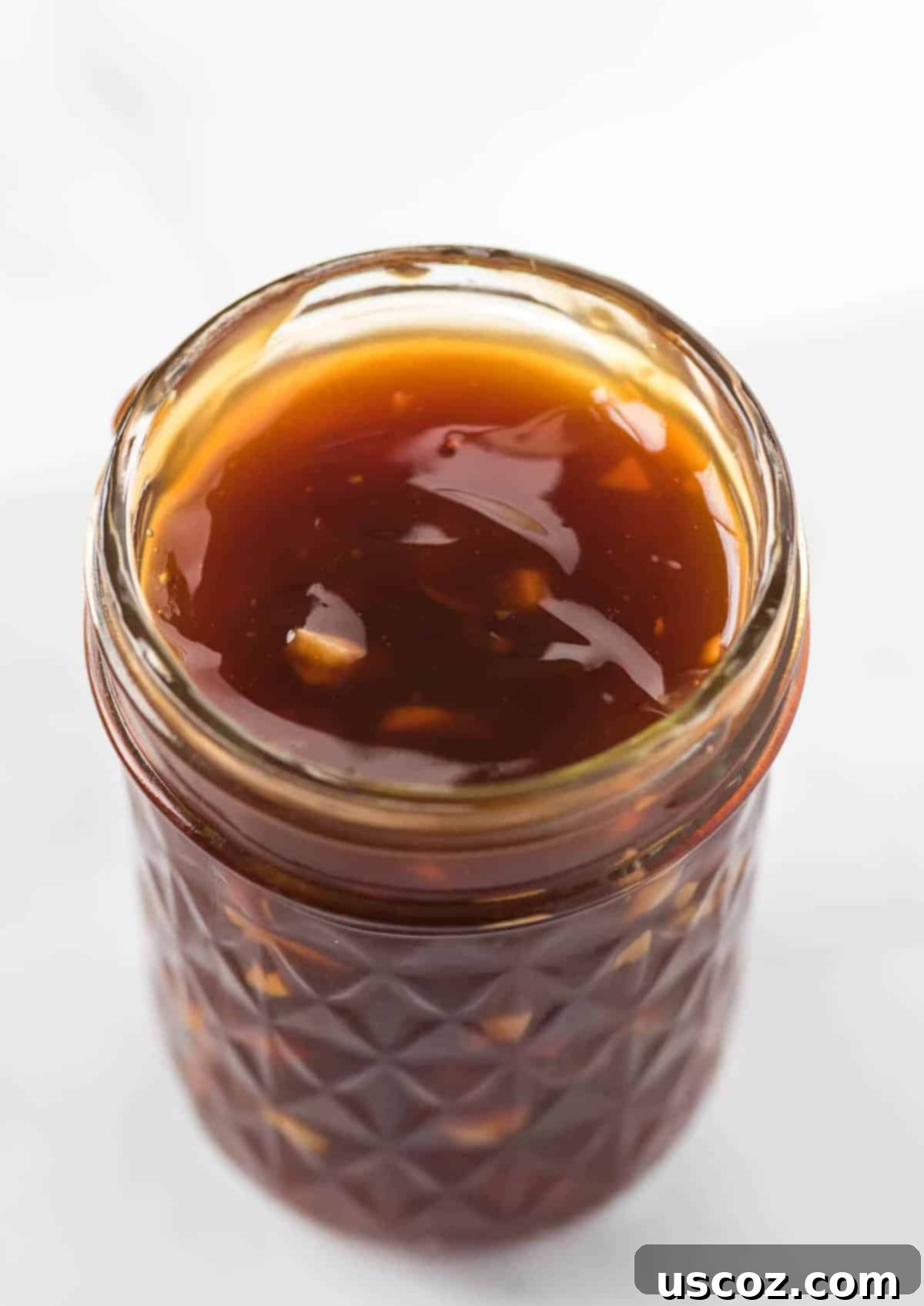 Homemade Teriyaki Sauce 2 A glass jar filled with rich, amber homemade teriyaki sauce, ready for use in marinades and stir-fries.