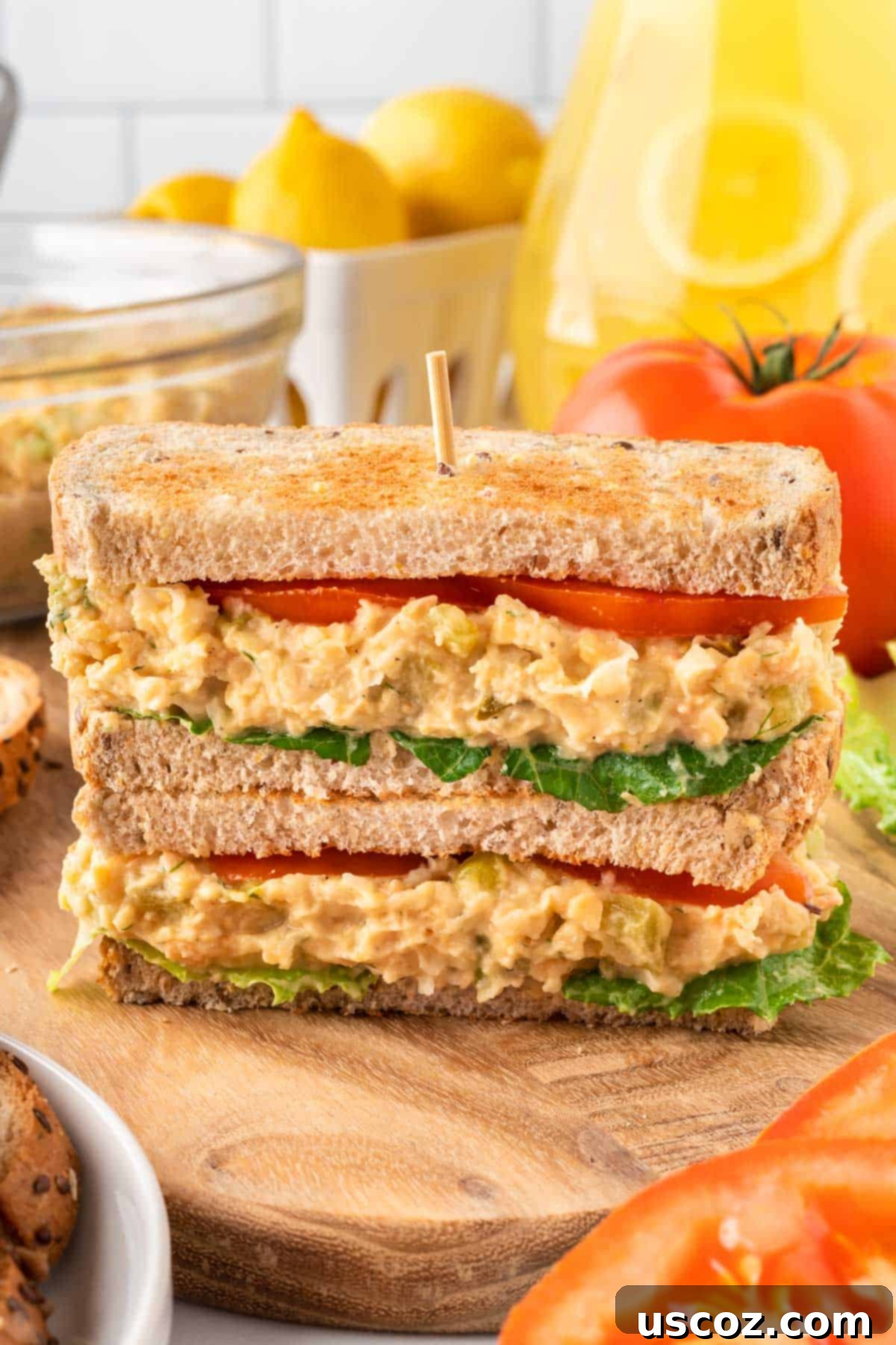 Creamy Dreamy Chickpea Salad Sandwich 11 Beautifully assembled chickpea salad sandwich on seeded bread with tomato and lettuce, ready to eat