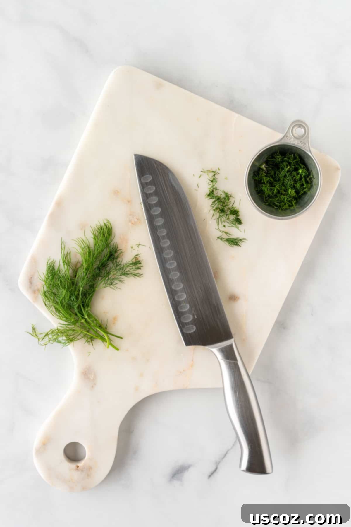 Creamy Dreamy Chickpea Salad Sandwich 5 Close-up of fresh dill being finely minced on a cutting board