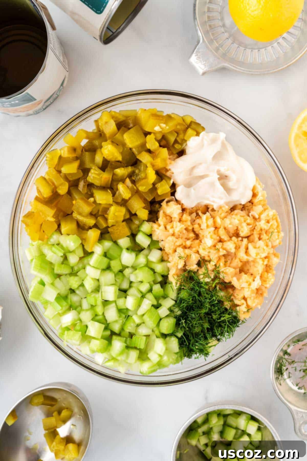 Creamy Dreamy Chickpea Salad Sandwich 8 Mixing bowl with mashed chickpeas, celery, vegan mayo, pickles, and dill being combined