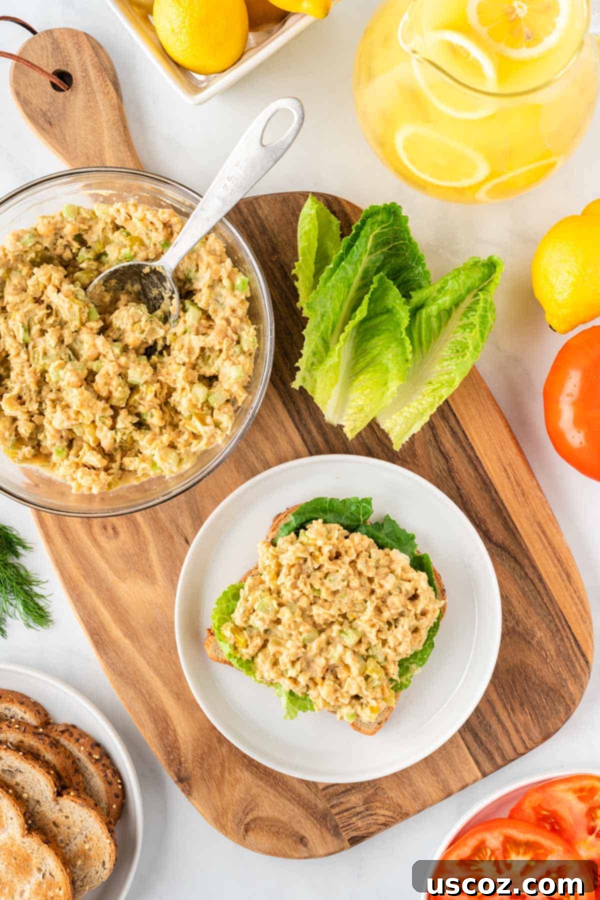 Creamy Dreamy Chickpea Salad Sandwich 10 Assembling a delicious chickpea chicken salad sandwich on bread with fresh lettuce leaves