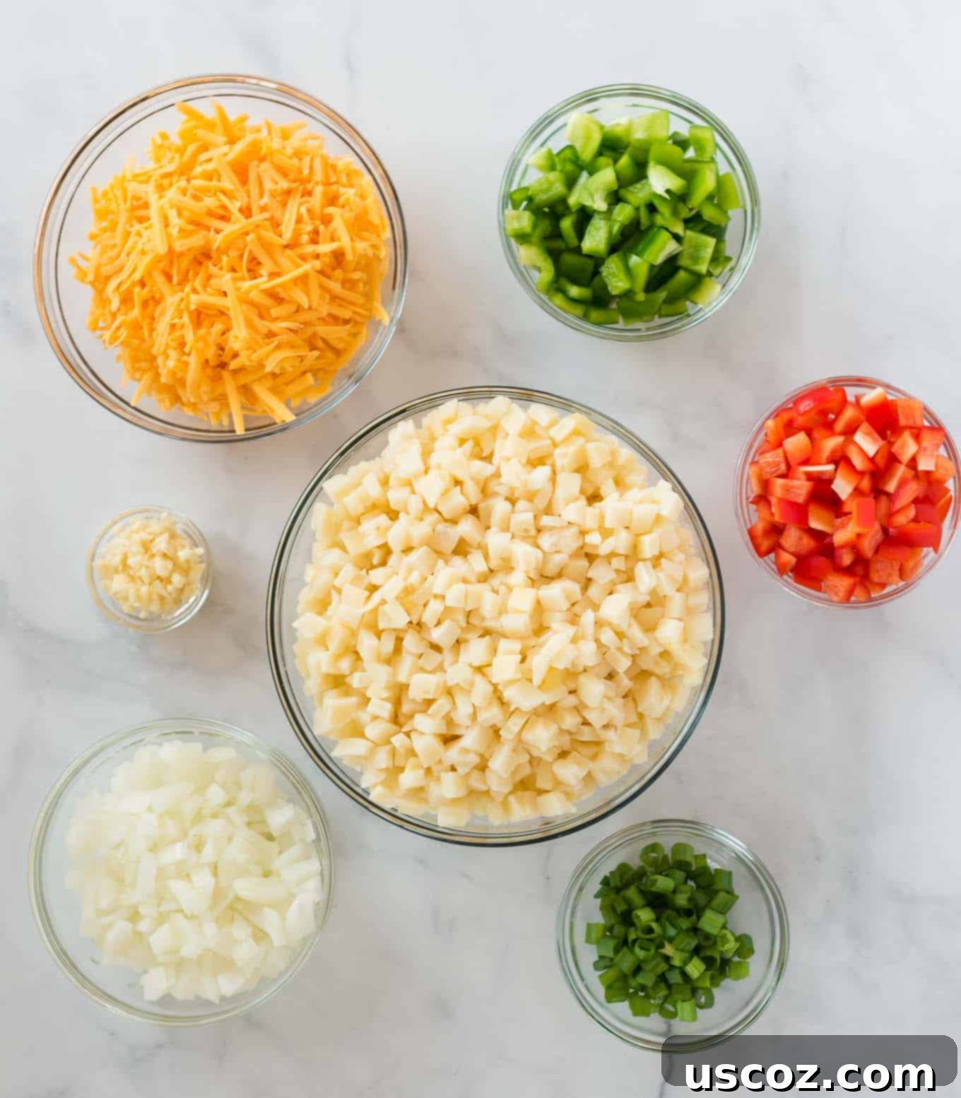 Golden Hash Brown Egg Bake 3 ingredients in separate glass bowls (potatoes, garlic, onion, bell pepper, cheese, green onions)