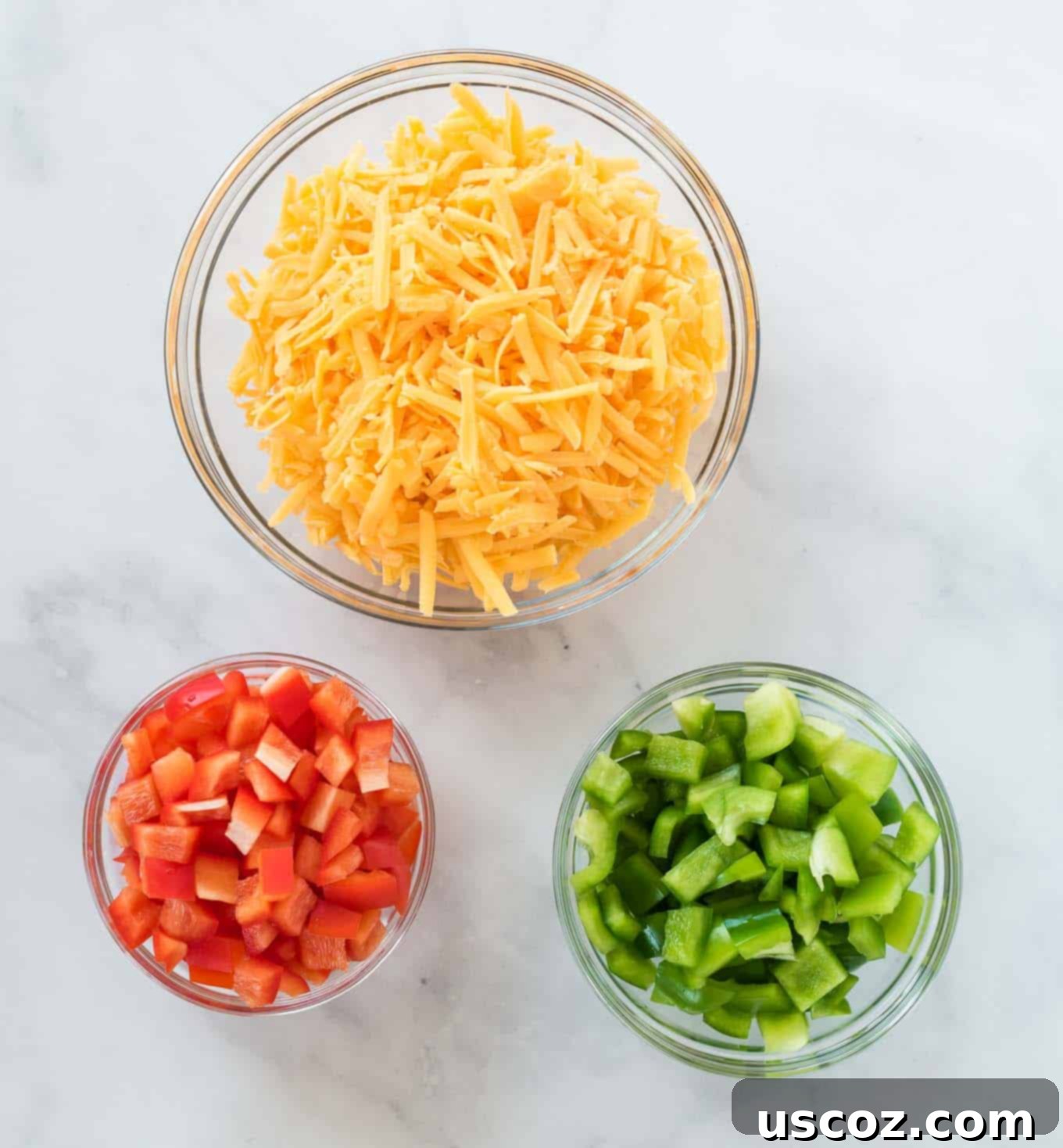 Golden Hash Brown Egg Bake 4 cheese, red bell pepper, and green bell pepper in separate glass bowls