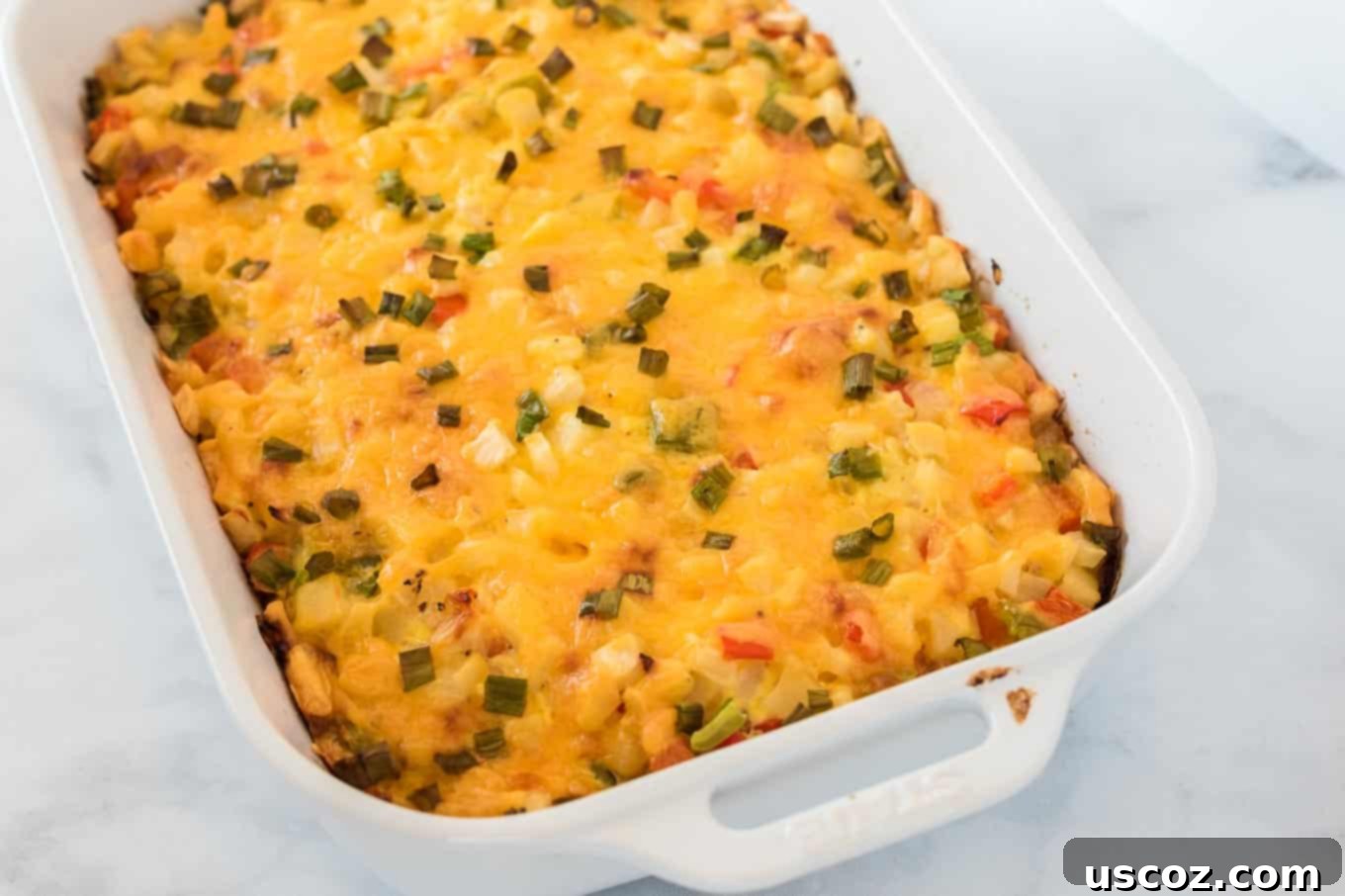 Golden Hash Brown Egg Bake 10 finished baked hash brown egg casserole in a white dish