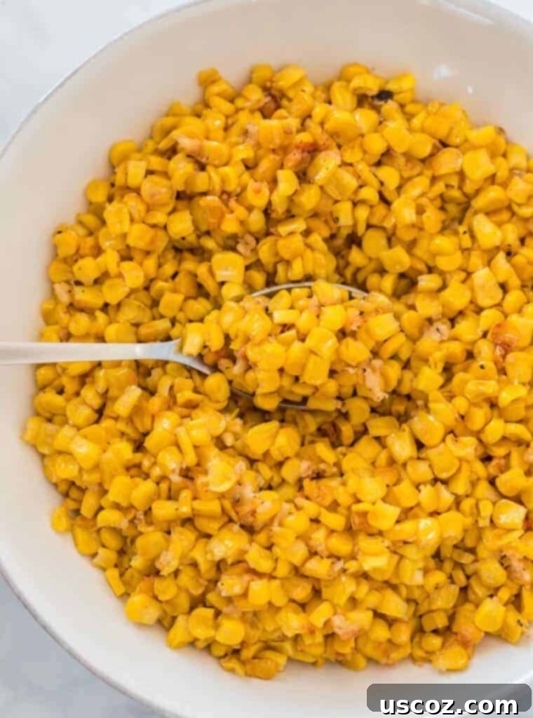 Crispy Roasted Frozen Corn 5 Serving bowl of roasted corn with a spoon, highlighting the texture