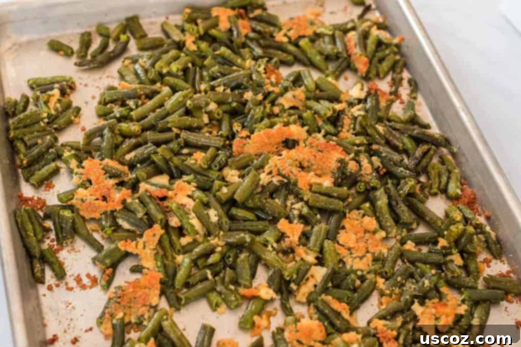 Crispy Roasted Frozen Green Beans 2 Crispy parmesan roasted green beans on a baking sheet, fresh out of the oven