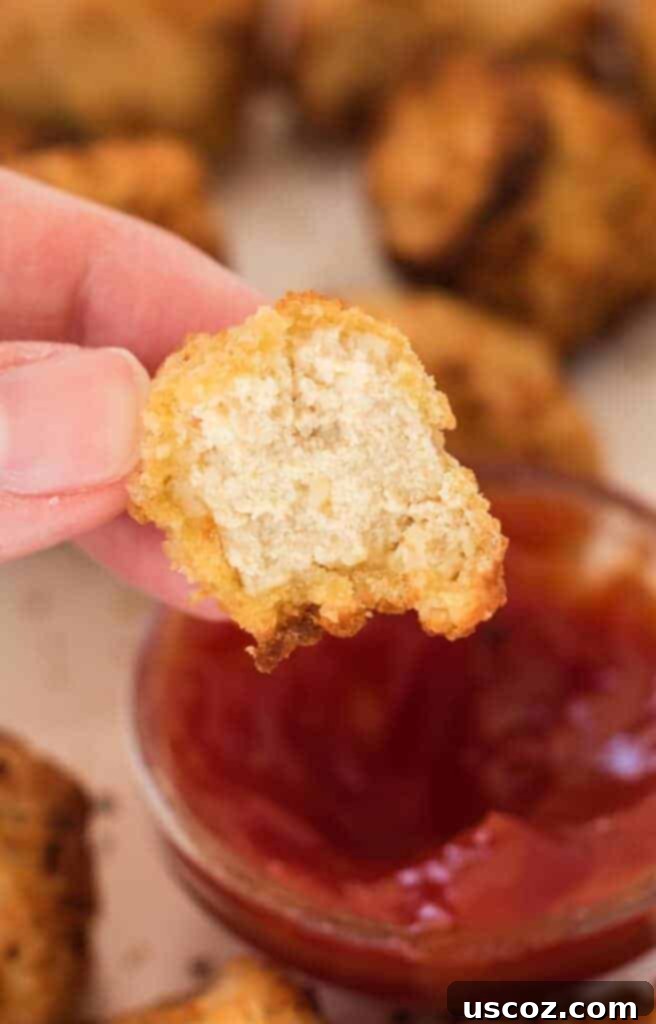 Crispy Air Fryer Tofu Nuggets 3 a bite taken out of a tofu nugget to show the meaty texture