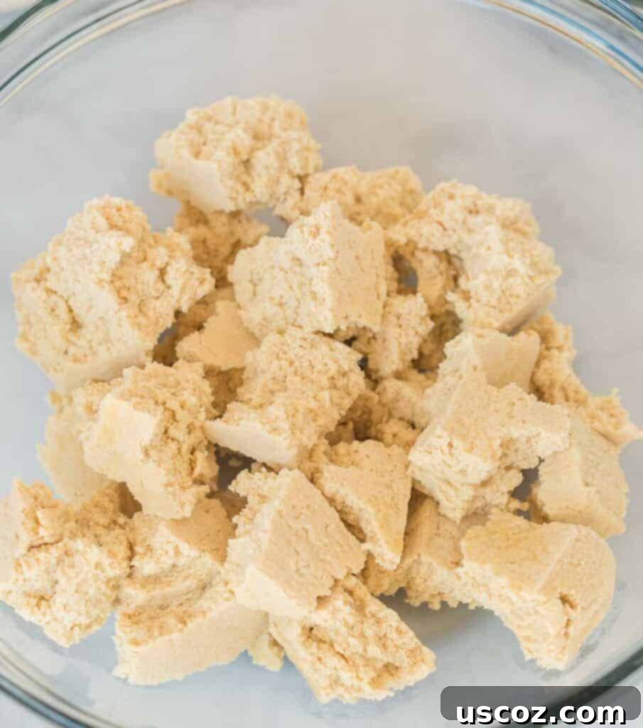 Crispy Air Fryer Tofu Nuggets 5 frozen tofu torn into bite sized pieces in a bowl
