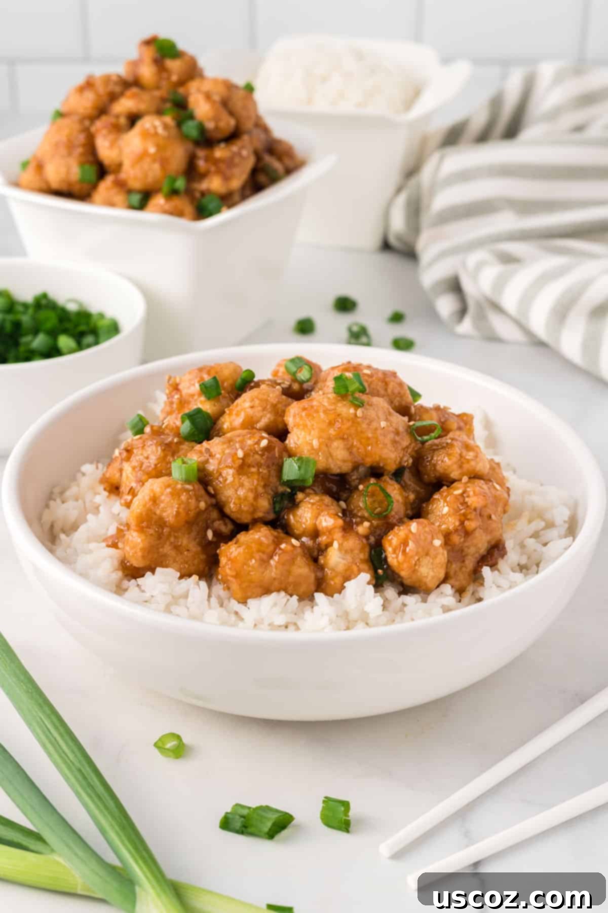 Sticky Teriyaki Cauliflower Bites 14 Teriyaki cauliflower served over fluffy white rice in a pristine white bowl, showcasing a complete meal.