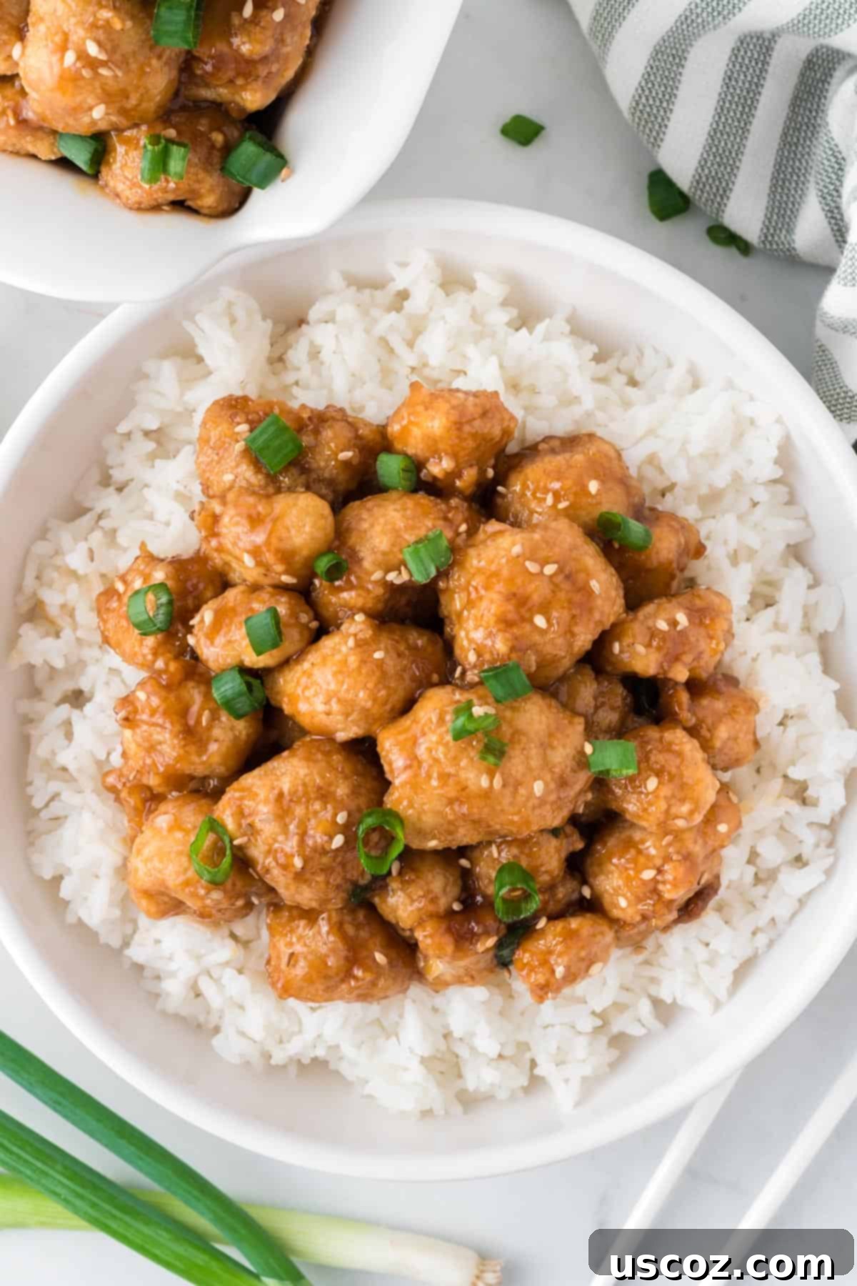 Sticky Teriyaki Cauliflower Bites 15 Another shot of teriyaki cauliflower served over rice in a white bowl, emphasizing its hearty and appealing presentation.
