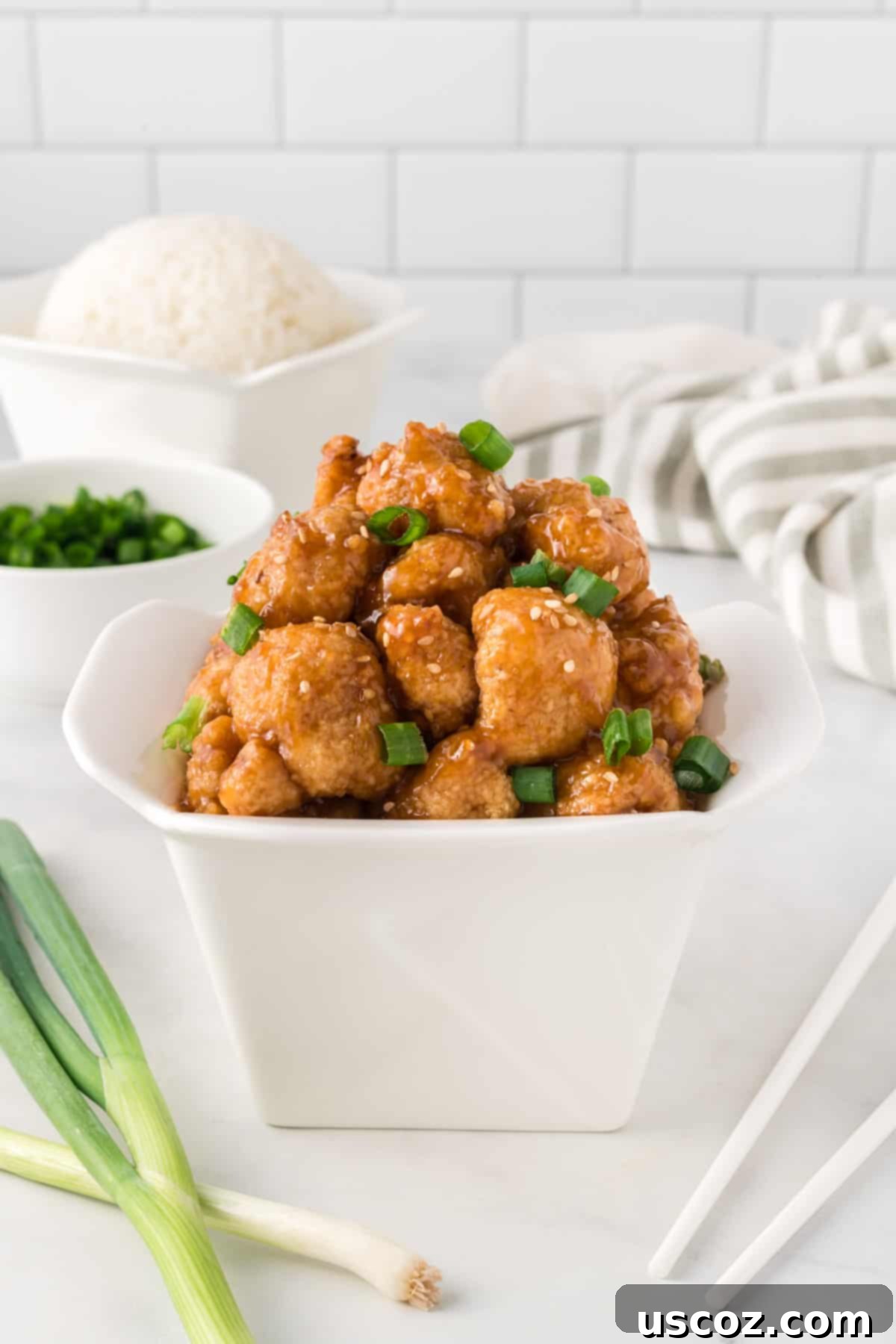 Sticky Teriyaki Cauliflower Bites 16 Teriyaki cauliflower packaged in a takeout-style container, ready for a convenient meal on the go.