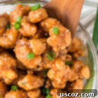 Sticky Teriyaki Cauliflower Bites 17 teriyaki cauliflower in a bowl topped with green onions and sesame seeds