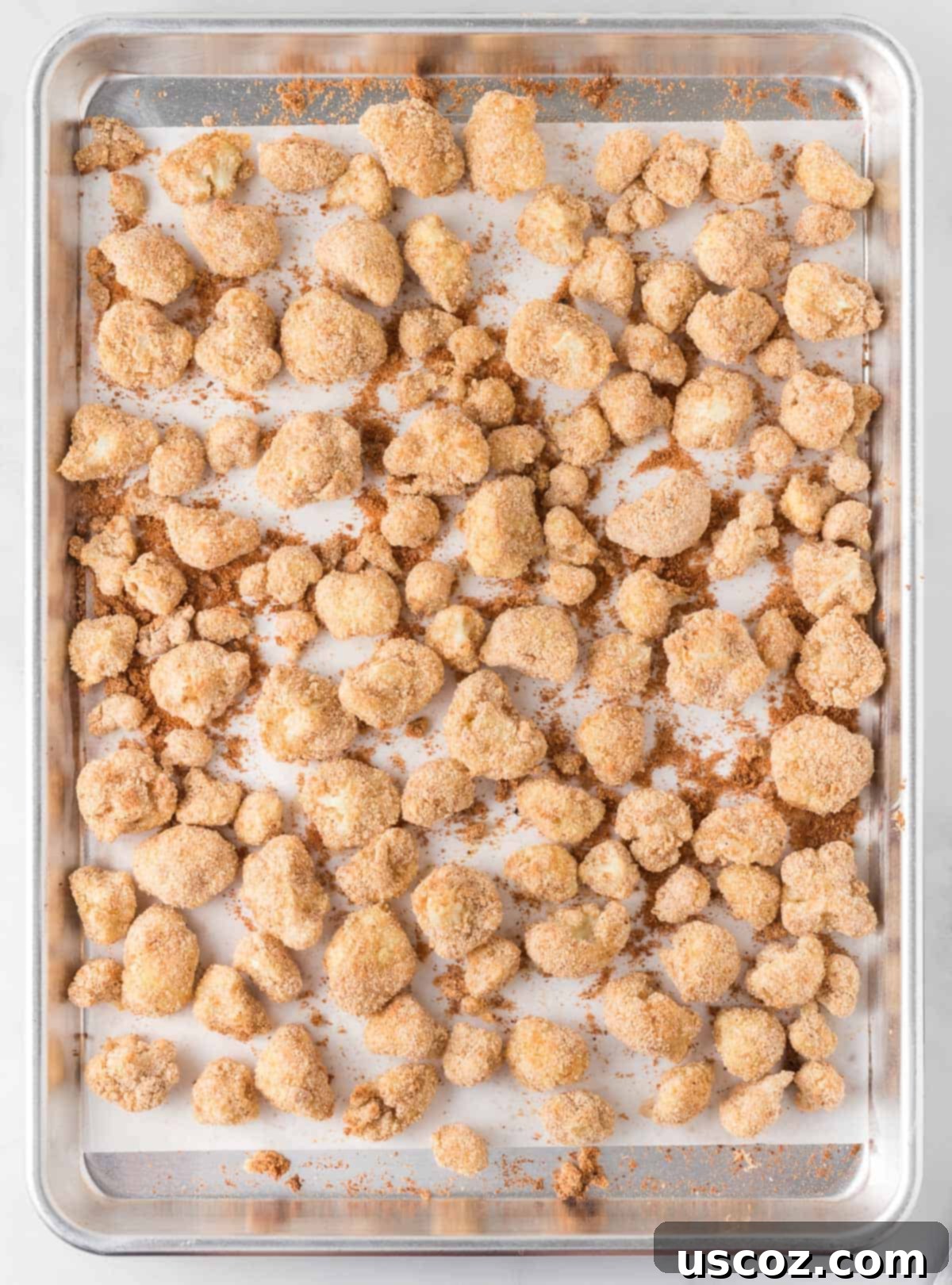 Sticky Teriyaki Cauliflower Bites 9 Freshly baked breaded cauliflower bites, golden and crispy, just removed from the oven.