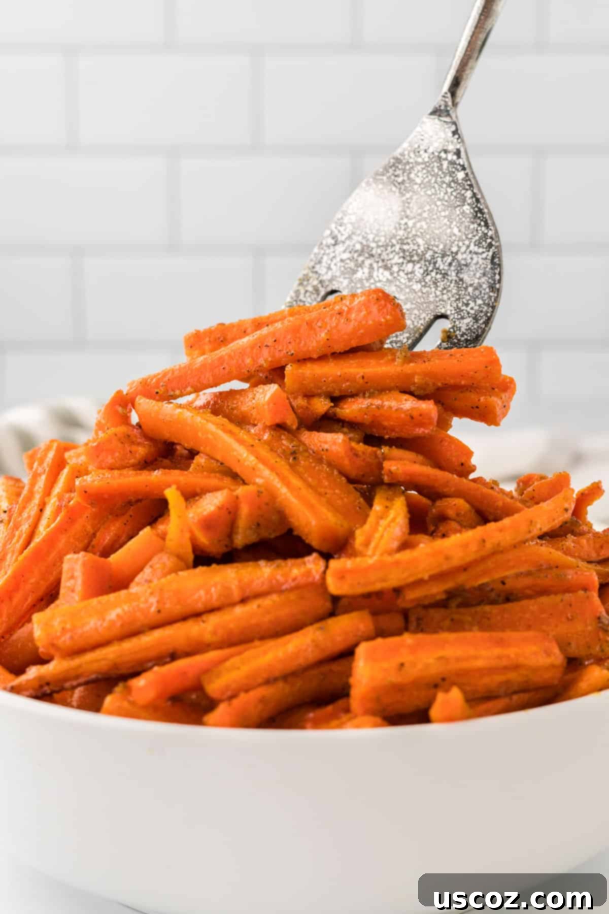 The Ultimate Roasted Carrots 13 taking roasted carrots from the bowl