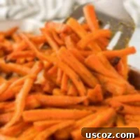 The Ultimate Roasted Carrots 14 spatula taking a serving of roasted carrots