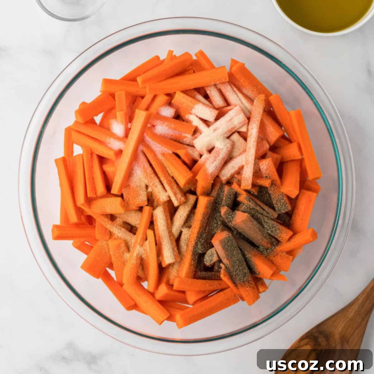 The Ultimate Roasted Carrots 6 spices added to the sliced carrots