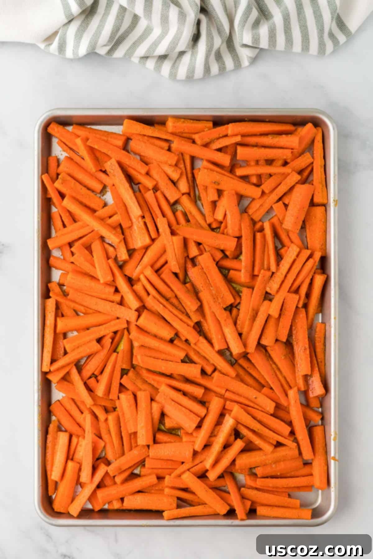 The Ultimate Roasted Carrots 8 carrots on a baking sheet